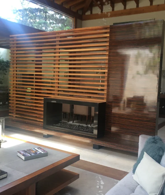 Ebony and lattice room divider with minimalist fireplace